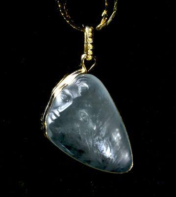 Aquamarine 37 ct. cats eye, carved face and eye, flash across body of stone