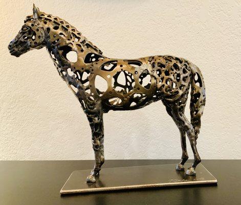 the first small horse sculpture in the  welded bicycle sprocket series.