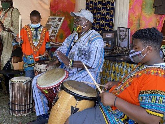 Cute family drumming in The Africa tent.