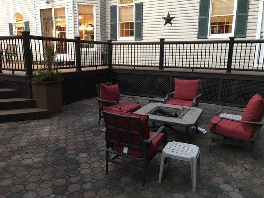 Patio by the new deck and storage door under deck. Planter box