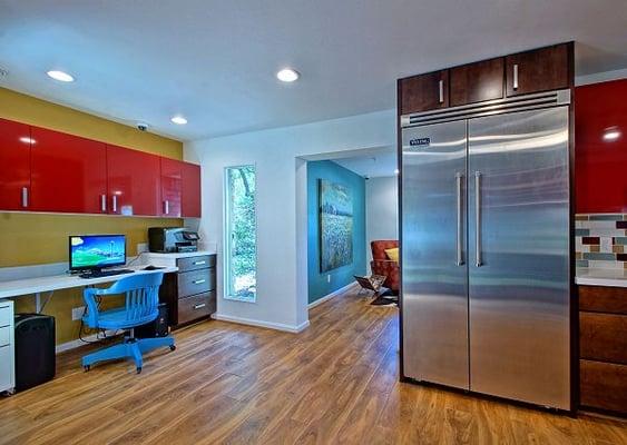 The caregivers' workstation opens up to the Kitchen and the adjacent TV Area