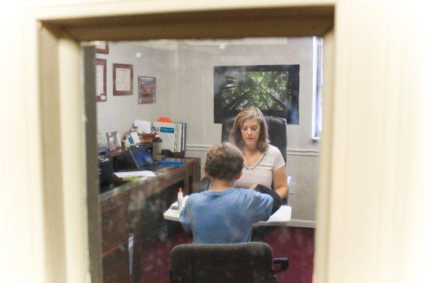 Parents and guardians can watch the session through the observation window.