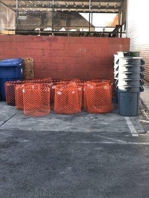 Baskets are used for cans and plastic. Barrels are used for glass.