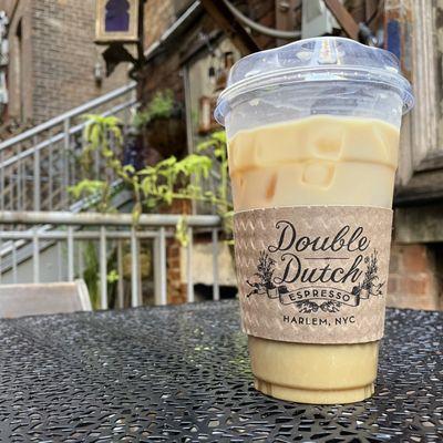 Iced coffee on table in the store's back patio