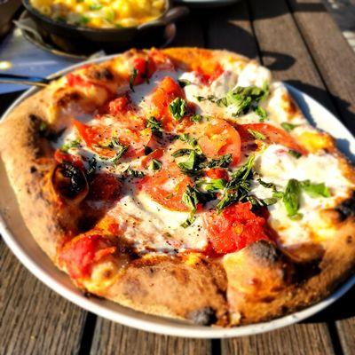 Entree Pizza with cheese, basil, and fresh tomatoes