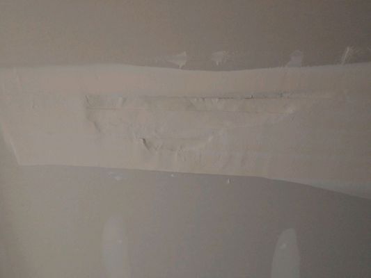 So instead of cutting out damaged sheetrock and putting a new piece in they taped over the hole.