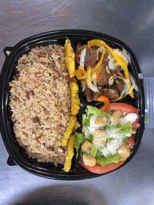 Our popular Caribbean Griot (Fried Pork) with a large side of brown rice and beans, plantains and a fresh side salad!