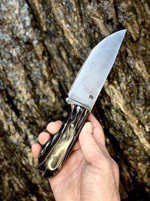 Drop point field knife with synthetic handle.