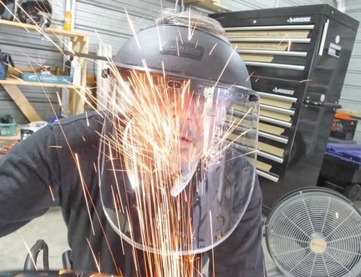 Full face shield protecting the operator from the grinding sparks.