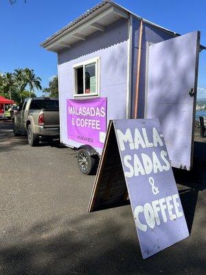 Look for their sign and can't miss the purple trailer at the corner of Kai Store.