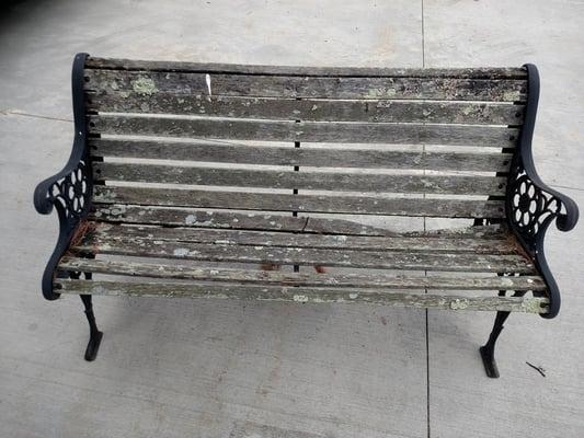 The antique Lionhead bench before restoration.