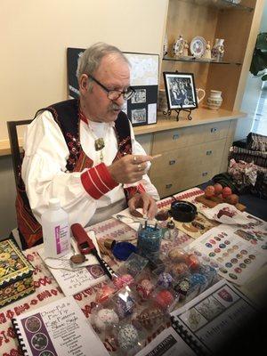 Decorating egg shells with color.