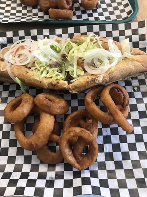 Cheesesteak hoagie with half a side of onion rings