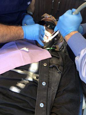 Lasering the tissue around the gums to prep for a crown.