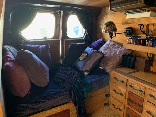 Cozy little Nissan NV200 solar camper conversion.