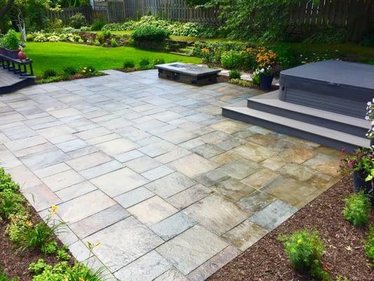 Cut Pennsylvania Blue Stone patio, with custom Timber Tech steps and built in hot tub.