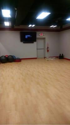 Spacious group room with Fitness On Demand for classes 24/7, mats, battling rope, plyo boxes, etc