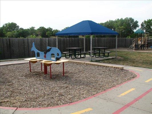 A sensory station and a picnic area is a great place to cool off in the summer heat.