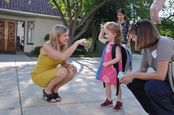 Ms. Musico greets a new student on the first day of school.