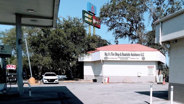 Tire shop located on the west side of chevron gas station.