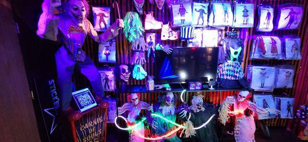 Various costumes and a TV that showed different horror clowns