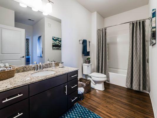 Spacious bathrooms with granite countertops and stainless steel fixtures