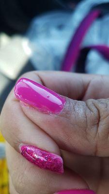 This is how my nail was left when I came to get it fixed. They messed it up more and hurt me with the burning glue.