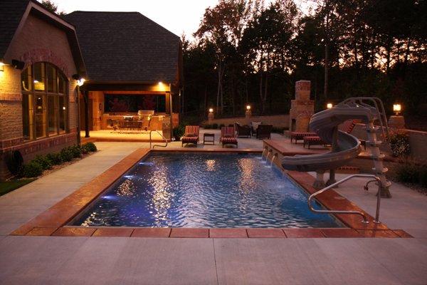 Gunite pool with fountain and waterslide.