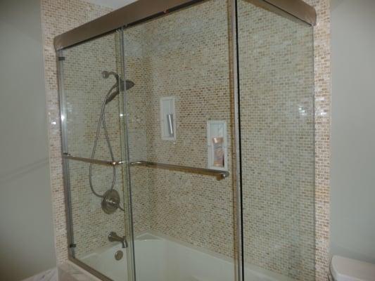 onyx tiles walls ,marble tiles niche and frame less shower door.( North Barrington )