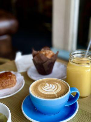 Latte, orange juice , croissant and Muffin