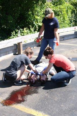 Erin (Instructor) demonstrates a real life trauma situation for our students.