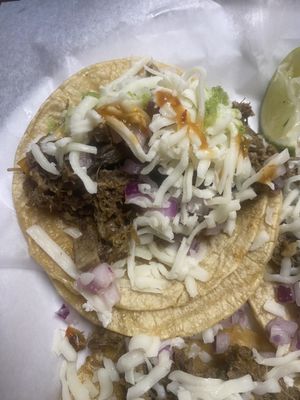 Beef Head Taco with cheese and hot sauce.