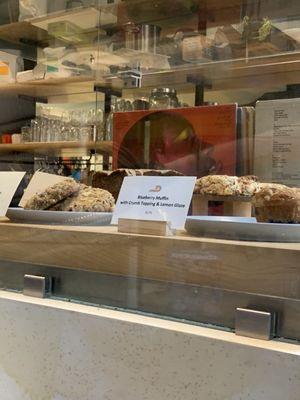 Display case of pastries with their Vinyl selection in the back!