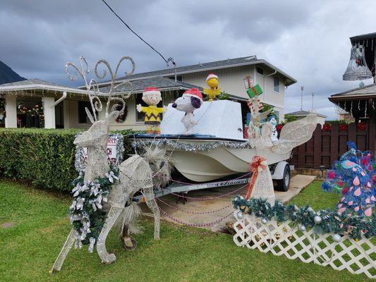 Snoopy, Woodstock, and Charlie Brown on a boat pulled by a reindeer!