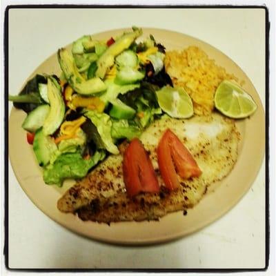 Fish fillet with rice and a side salad.