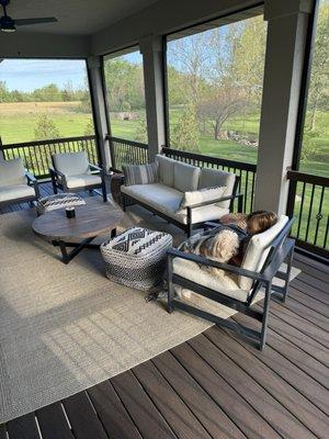 Back porch after screenwarehouse installed modern looking black frame screen system.