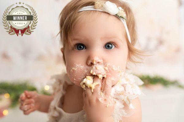 A one year old girl during a cake smash session