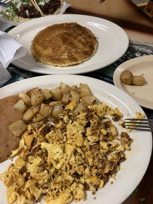 Eggs, chorizo, beans and potato with a pancake on the side