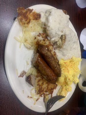 Partially consumed sausage biscuits and gravy breakfast