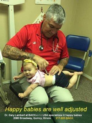 Dr. Gary Lambert adjusting his infant daughter.