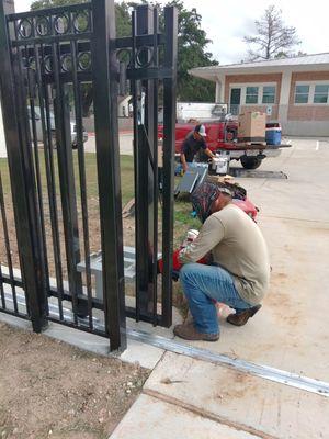 The Crew  working hard installing a new liftmaster csl24ul gate operator and a new sliding driveway gate.