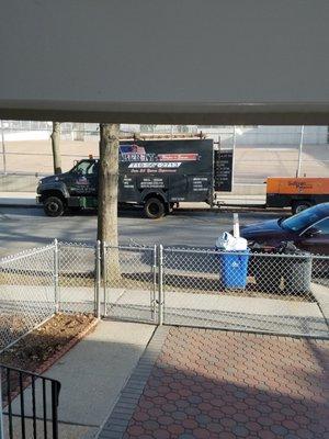 Liberty truck standing idly by watching wires be ripped down