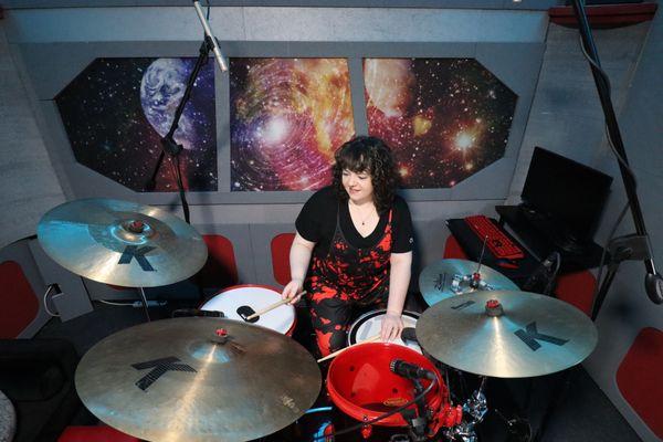 Lindsay Artkop drumming in her spaceship studio