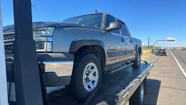 Towing a broken down vehicle off the side of the highway