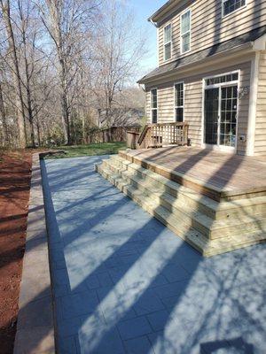 Wrap around steps, stamped concrete, and retaining wall, after drains put in