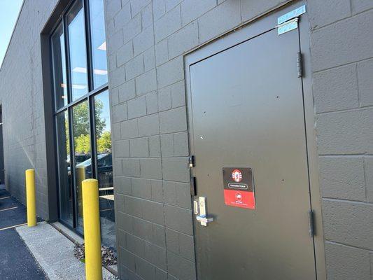 Wide shot of customer pickup area in parking lot.