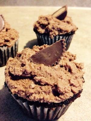 Dark chocolate cake with chocolate peanut butter frosting and a Reese's peanut butter cup on top