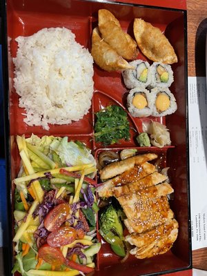 Chicken teriyaki bento box that came with miso soup, beef dumplings, ginger dressing salad, California roll and spicy tuna roll