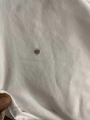 Cigarette hole in sheet.