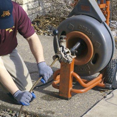 Cleaning a drain with an electric main line mach.